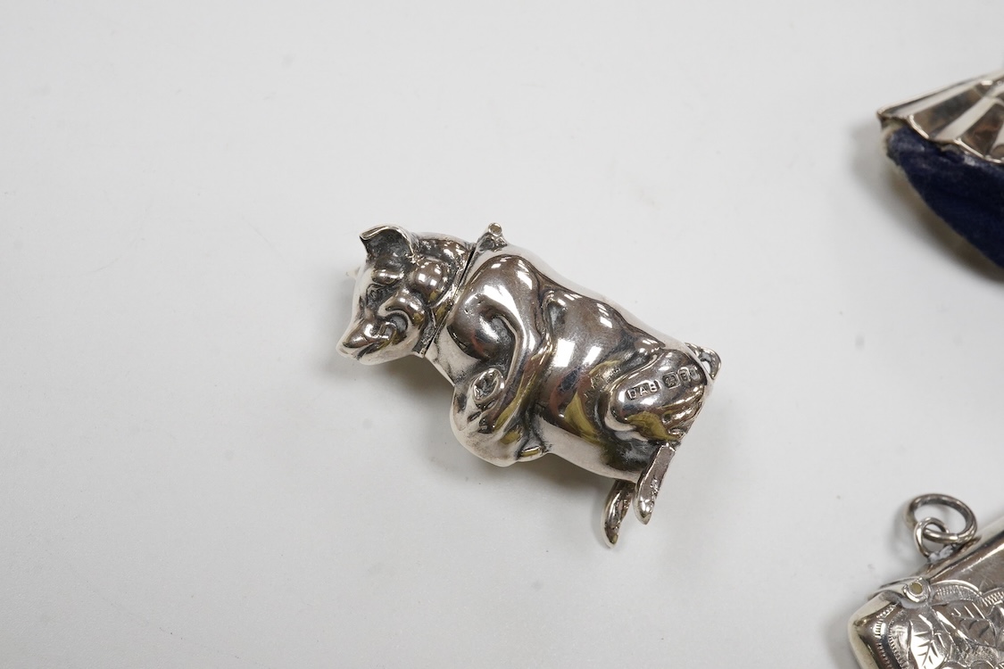 A George V silver mounted fan pin cushion, Henry Matthews, Birmingham, 1912, width 62mm, together with an Edwardian silver vesta case and a white metal pig vesta case.